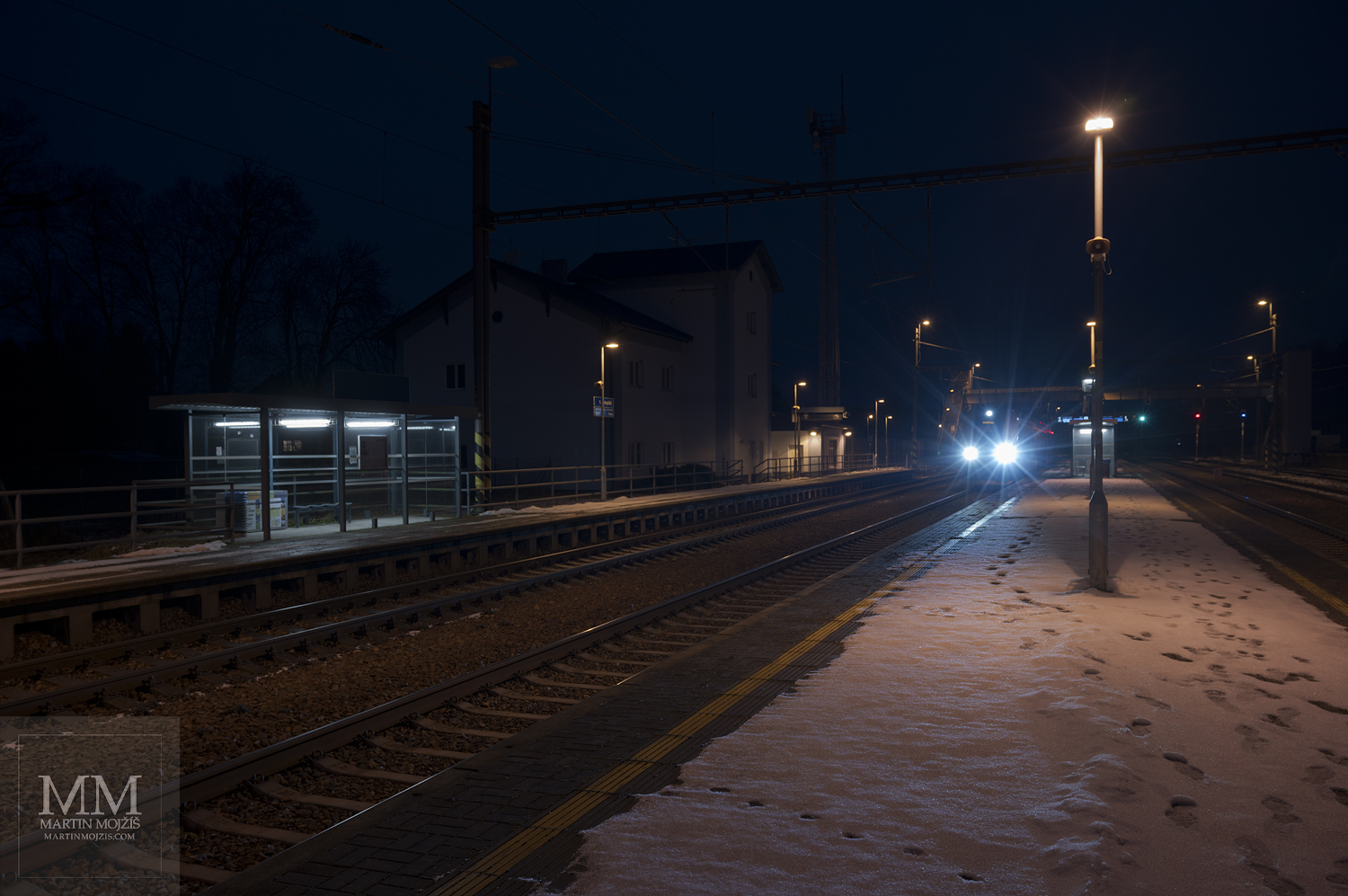 Night passenger train at the station before departure towards Pilsen.