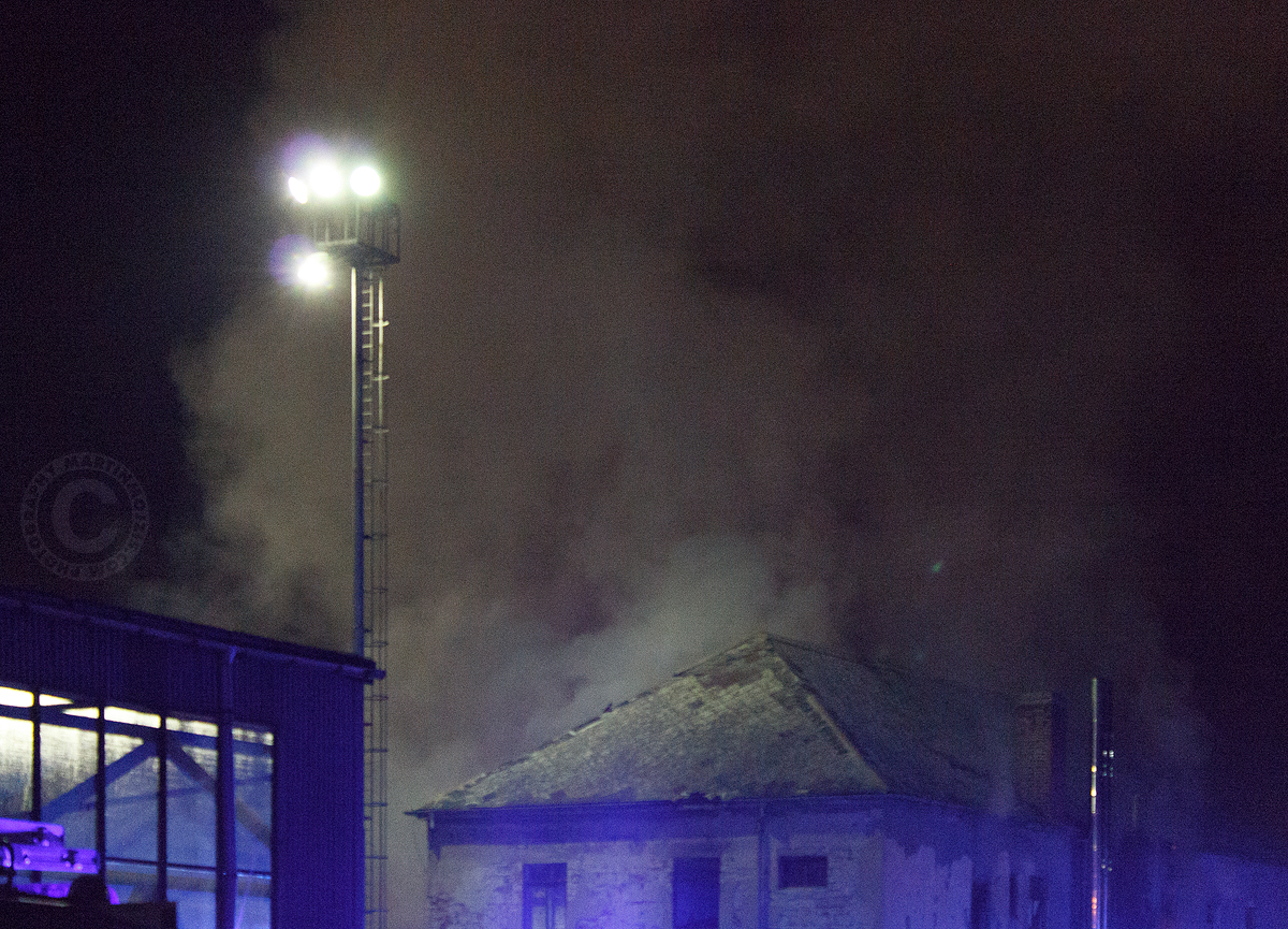Hořící dům a oblaka kouře ve světle nádražních lamp. Požár v Kralupech nad Vltavou.
