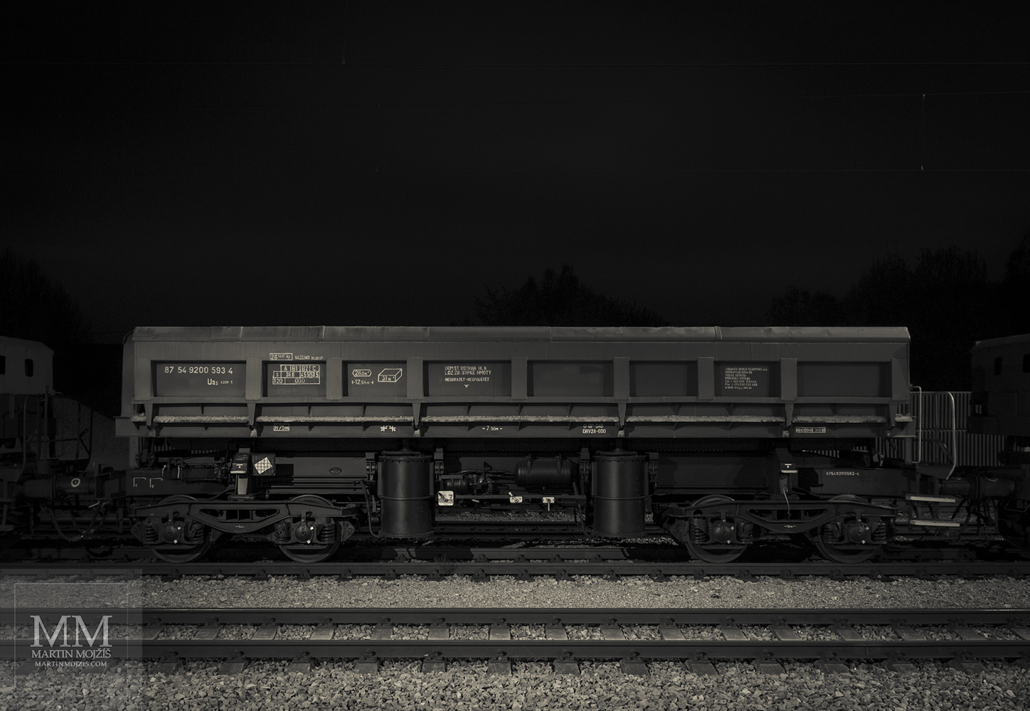 Wagon for transporting gravel. Karizek railway station at night.