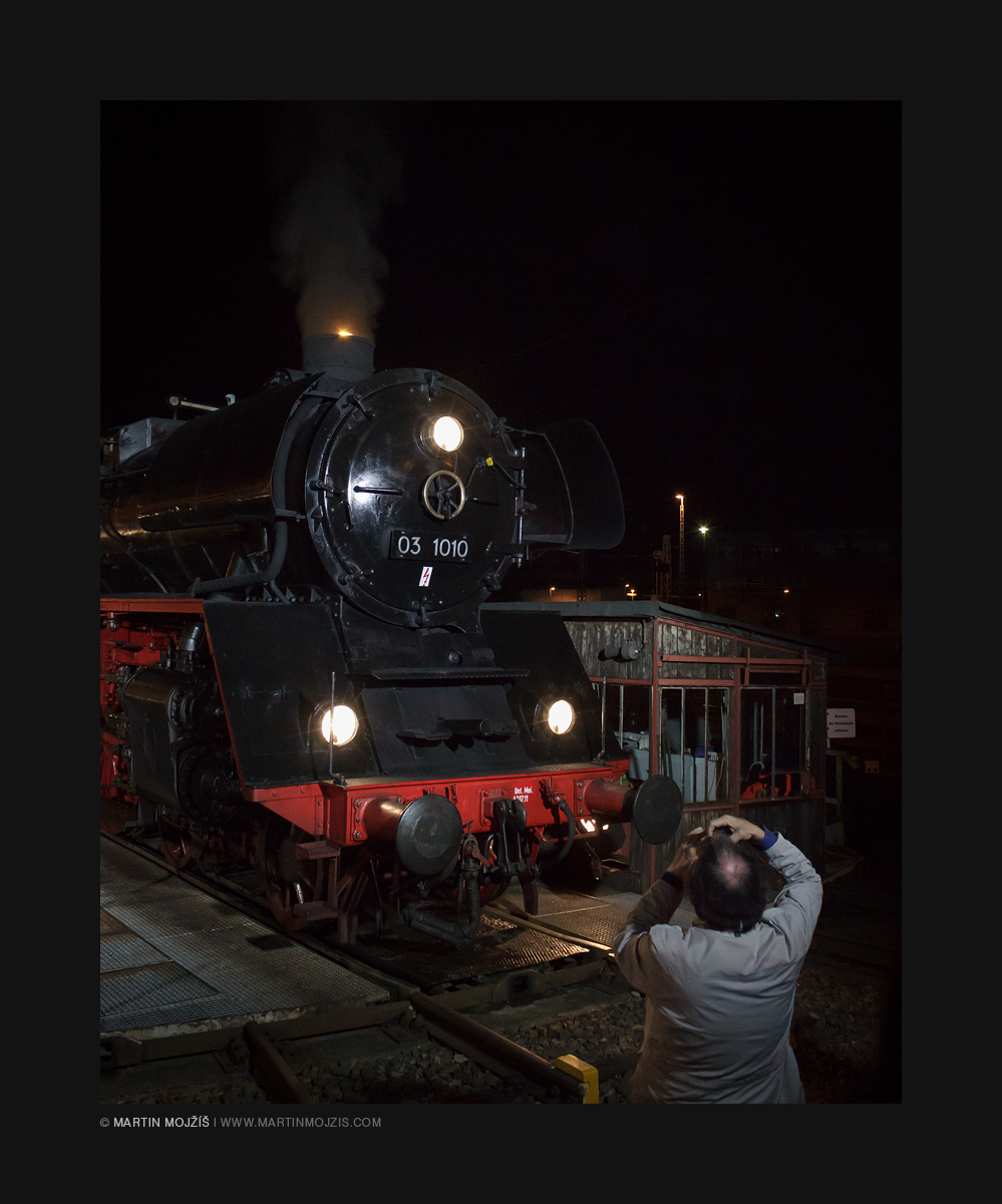 Photographer photographing a steam locomotive.
