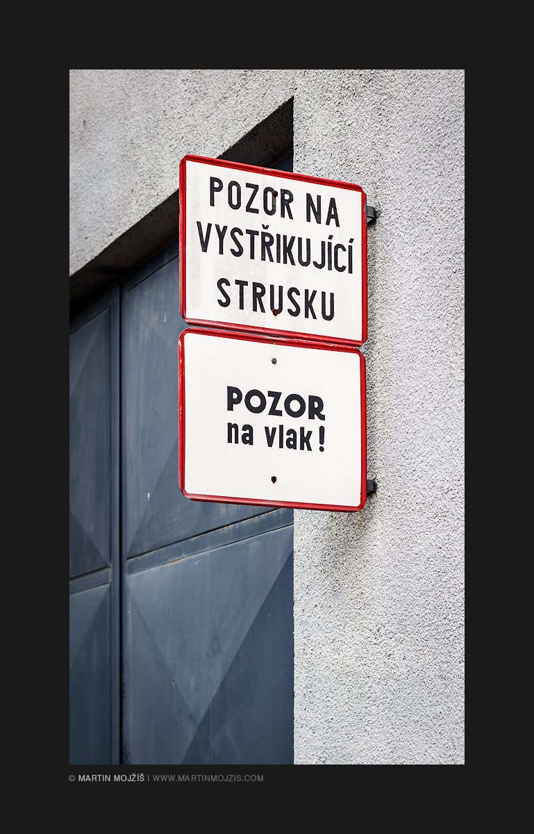 Nápisy upozorňující na vystřikující strusku a projíždějící vlak. Železniční muzeum v Lužné u Rakovníka.