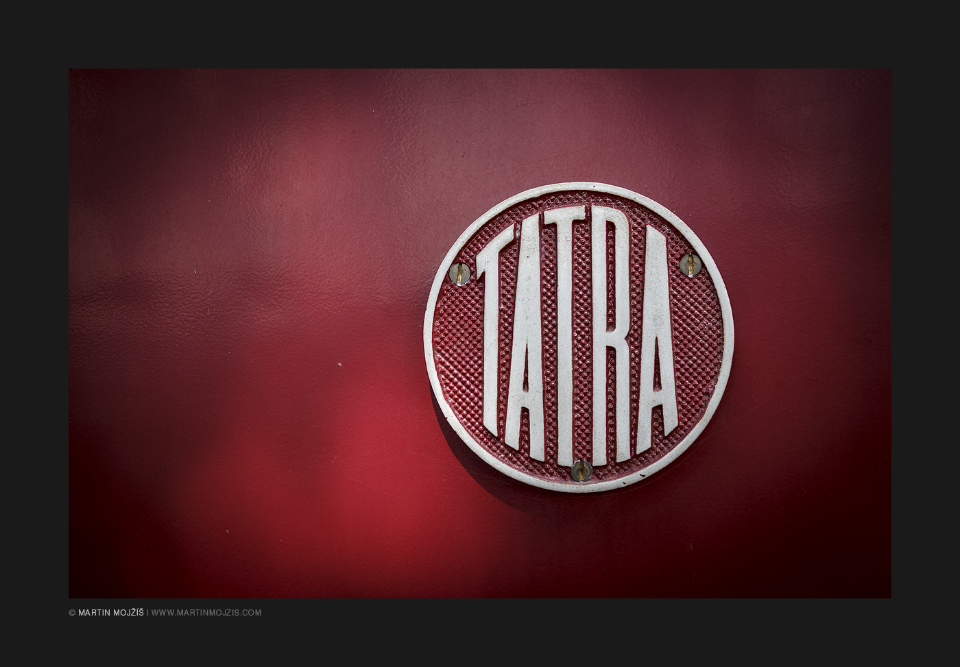 A TATRA emblem on a red engine train M131 1238 in a close-up view. Kolesovka 2017.