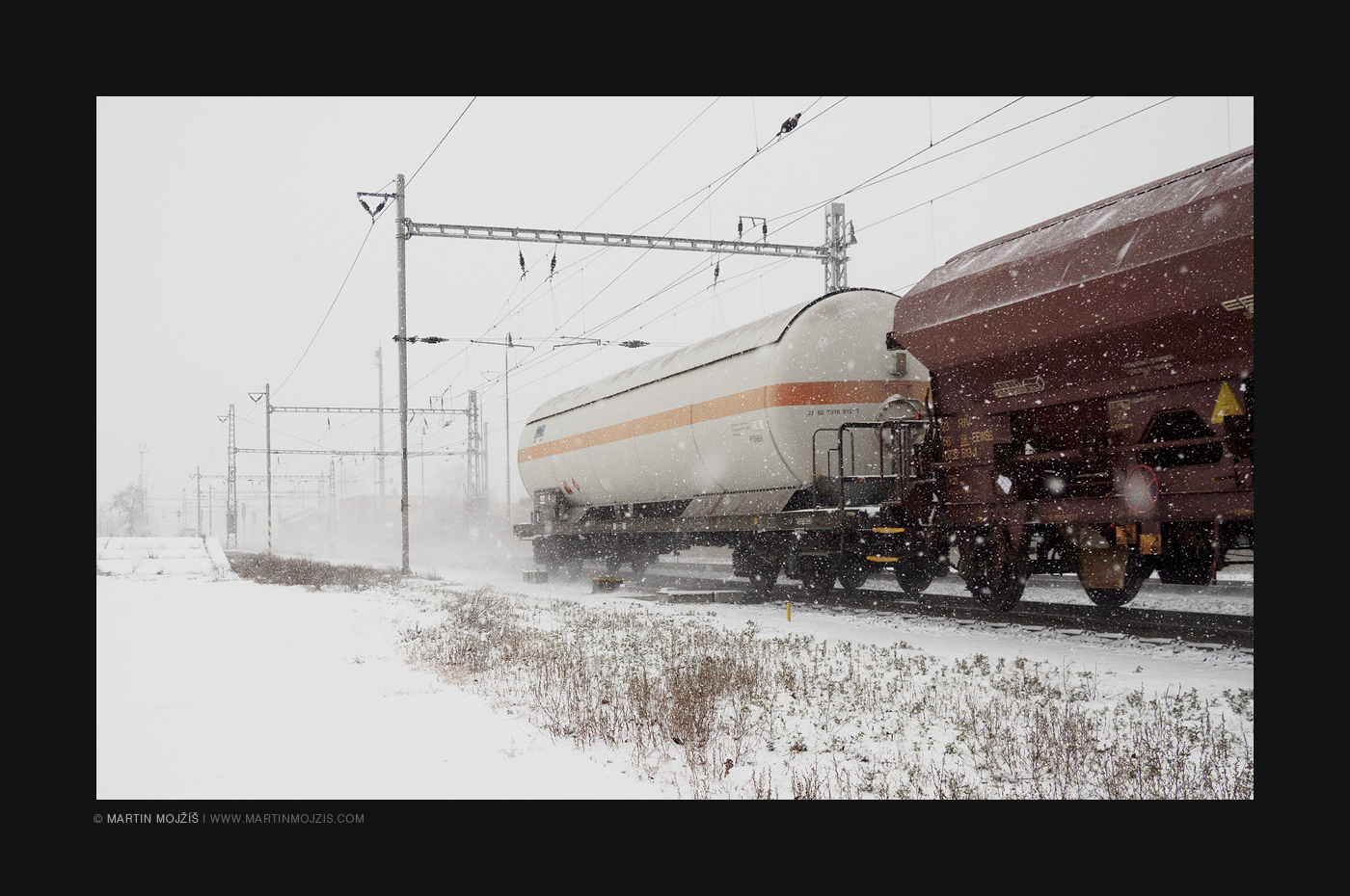 Freight train in snow blizzard.