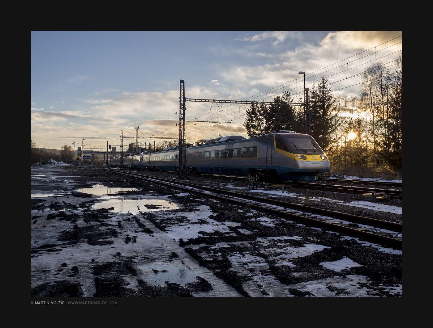 Pendolino train in Pilsen direction in rays of setting Sun.