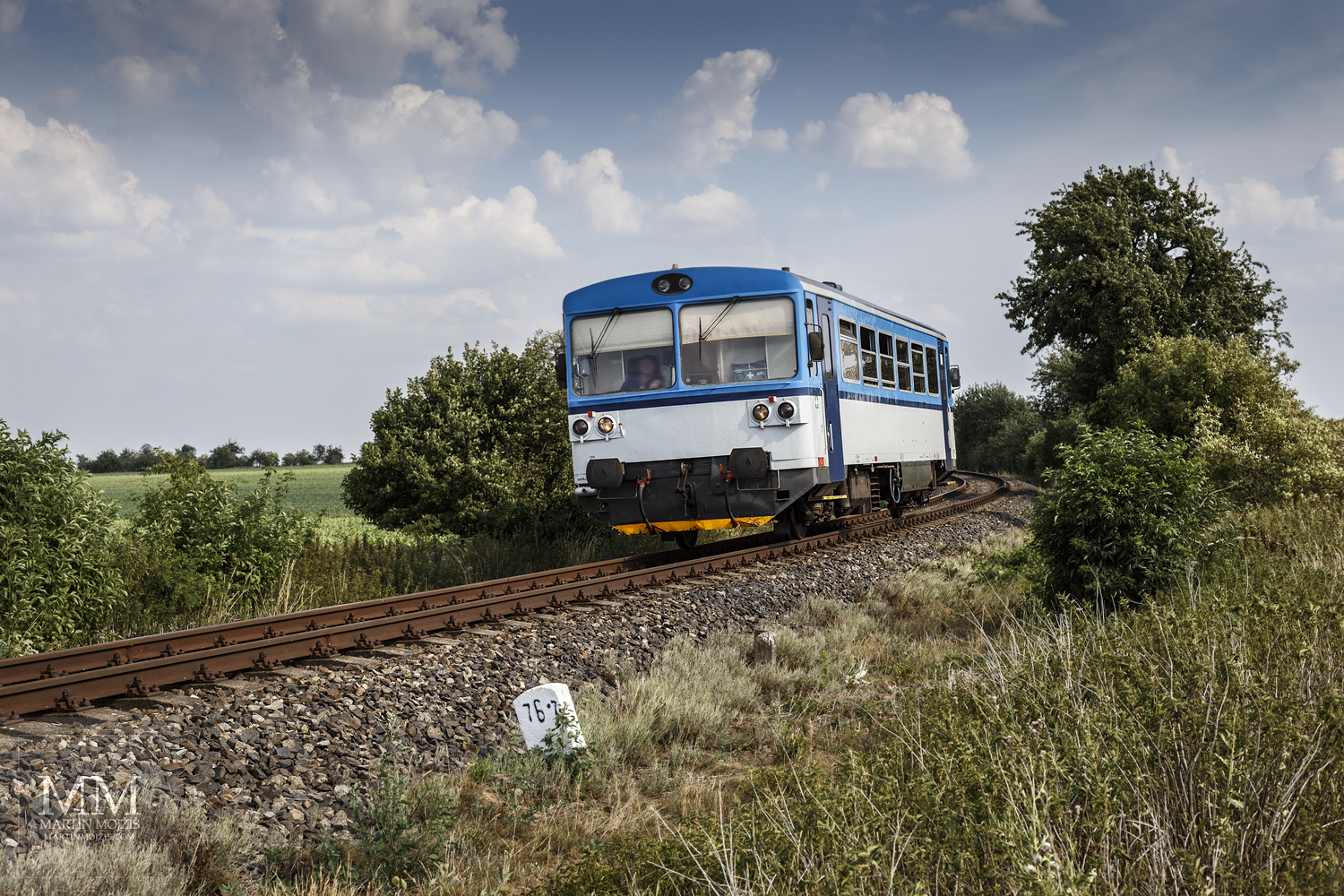 Large format, fine art photograph of small blue and white train. Martin Mojzis.