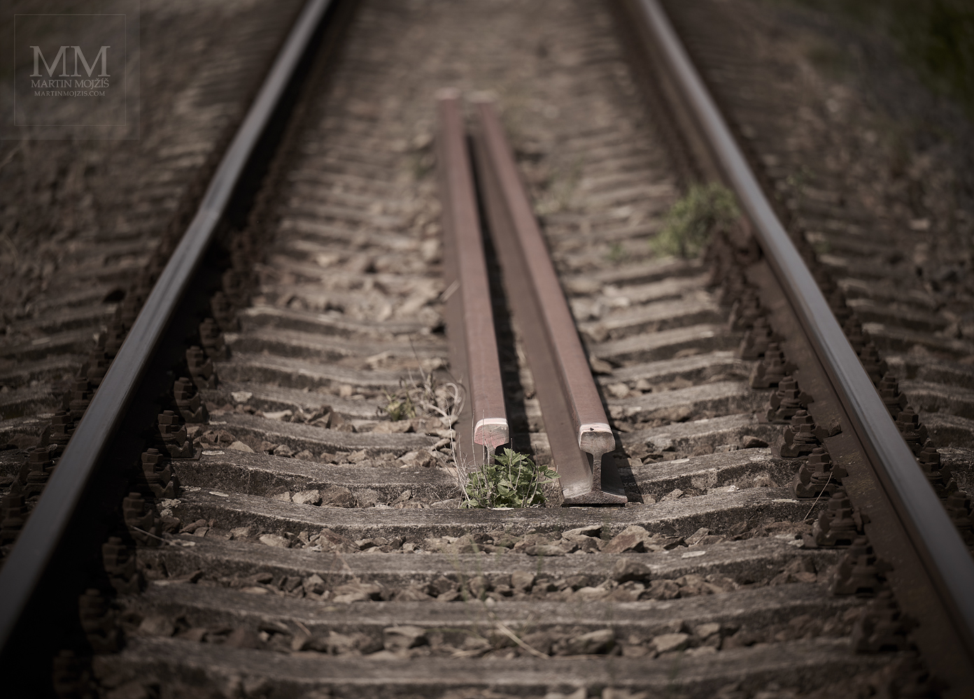 The railway rails in a railway track. Fine art photograph BEFORE A REPAIR, photographed by Martin Mojzis.