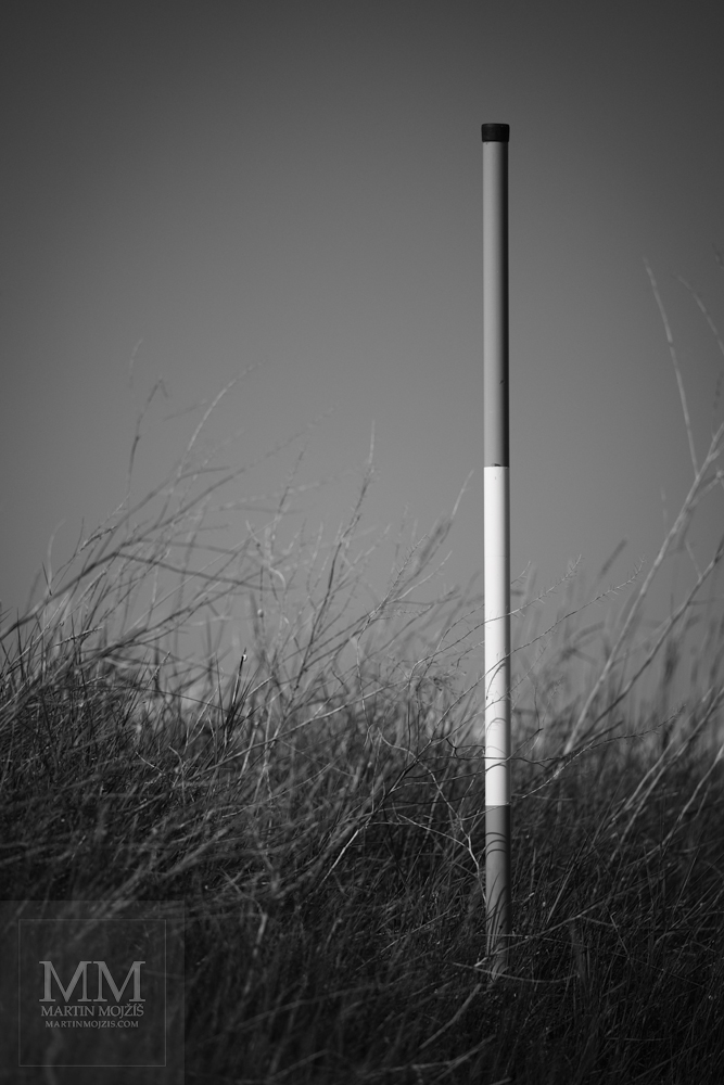 Metal post with stripes, railway signal Little Whistler. Fine art black and white photograph LITTLE WHISTLER, photographed by Martin Mojzis.
