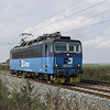 A blue electric locomotive Skoda going on a railway track.