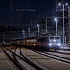 Train passing Beroun railway station at night.
