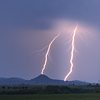 Landscape during a storm, two lightnings.