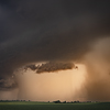 Supercell, supercell storm - a storm cloud and a rotating stream of air over the landscape.