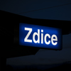 A illuminated name of the Zdice railway station at dusk.